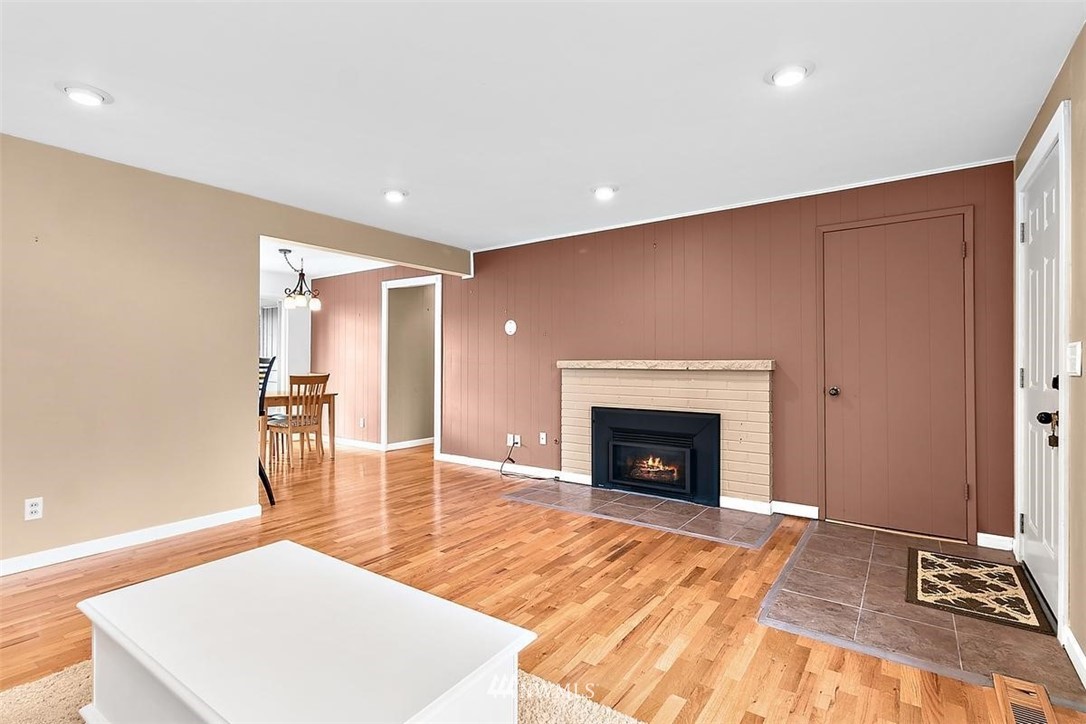 3407 Northeast 11th Street Renton, WA 98056 - Photo 6 of 27 a living room with a fireplace furniture and a wooden floor