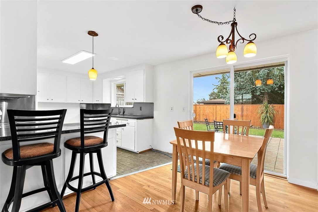 3407 Northeast 11th Street Renton, WA 98056 - Photo 7 of 27 a dining room with furniture a window and wooden floor