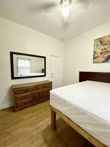 a bedroom with a bed and a dresser