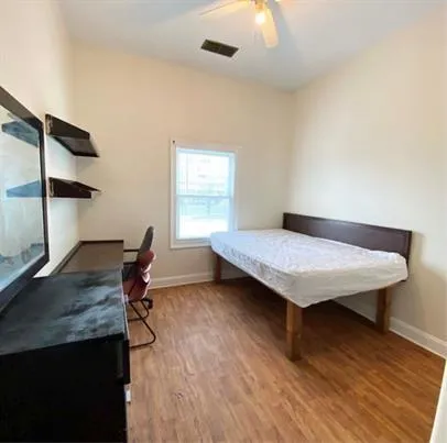 a living room with dining room and wooden floor