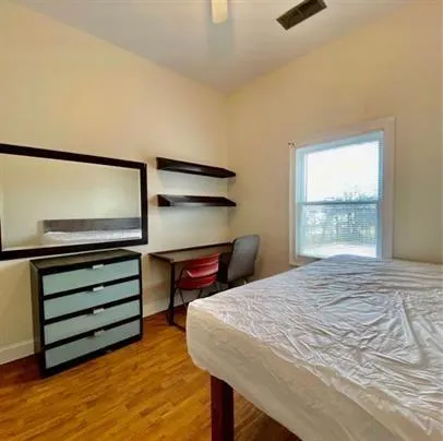 a bedroom with a bed and a window