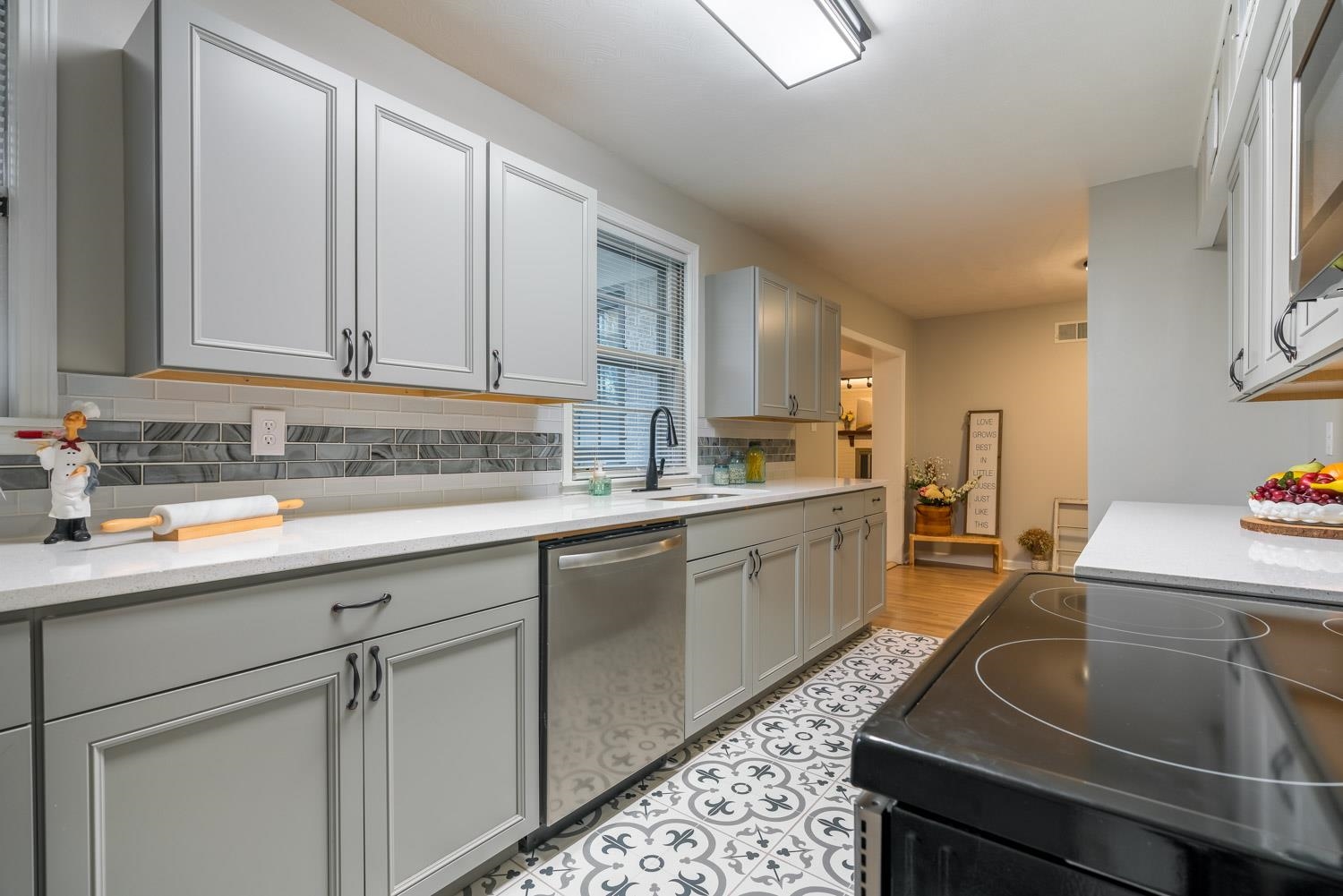 1854 Cherry Road Memphis, TN 38117 - Photo 12 of 25 a kitchen with kitchen island granite countertop a sink dishwasher stove and cabinets