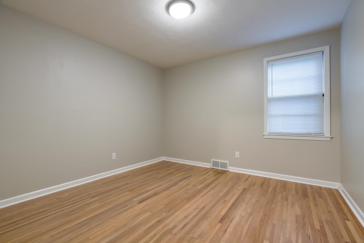 1854 Cherry Road Memphis, TN 38117 - Photo 18 of 25 an empty room with wooden floor and windows