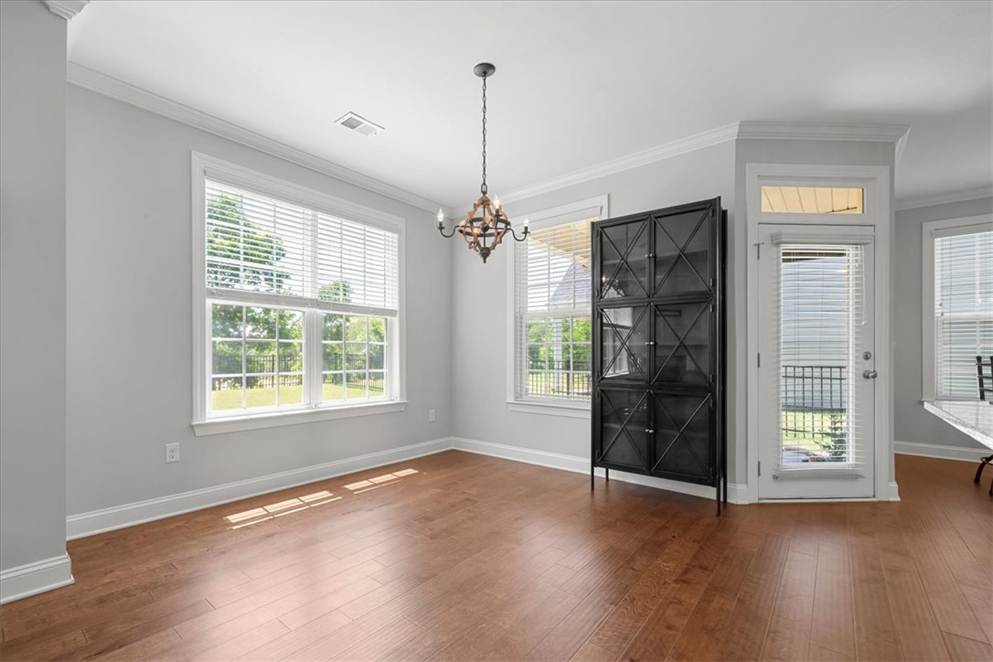 21 Barron Glenn Way Anderson, SC 29621 - Photo 20 of 48 This naturally illuminated room features gleaming hardwood floors and a striking chandelier, creating an inviting atmosphere.