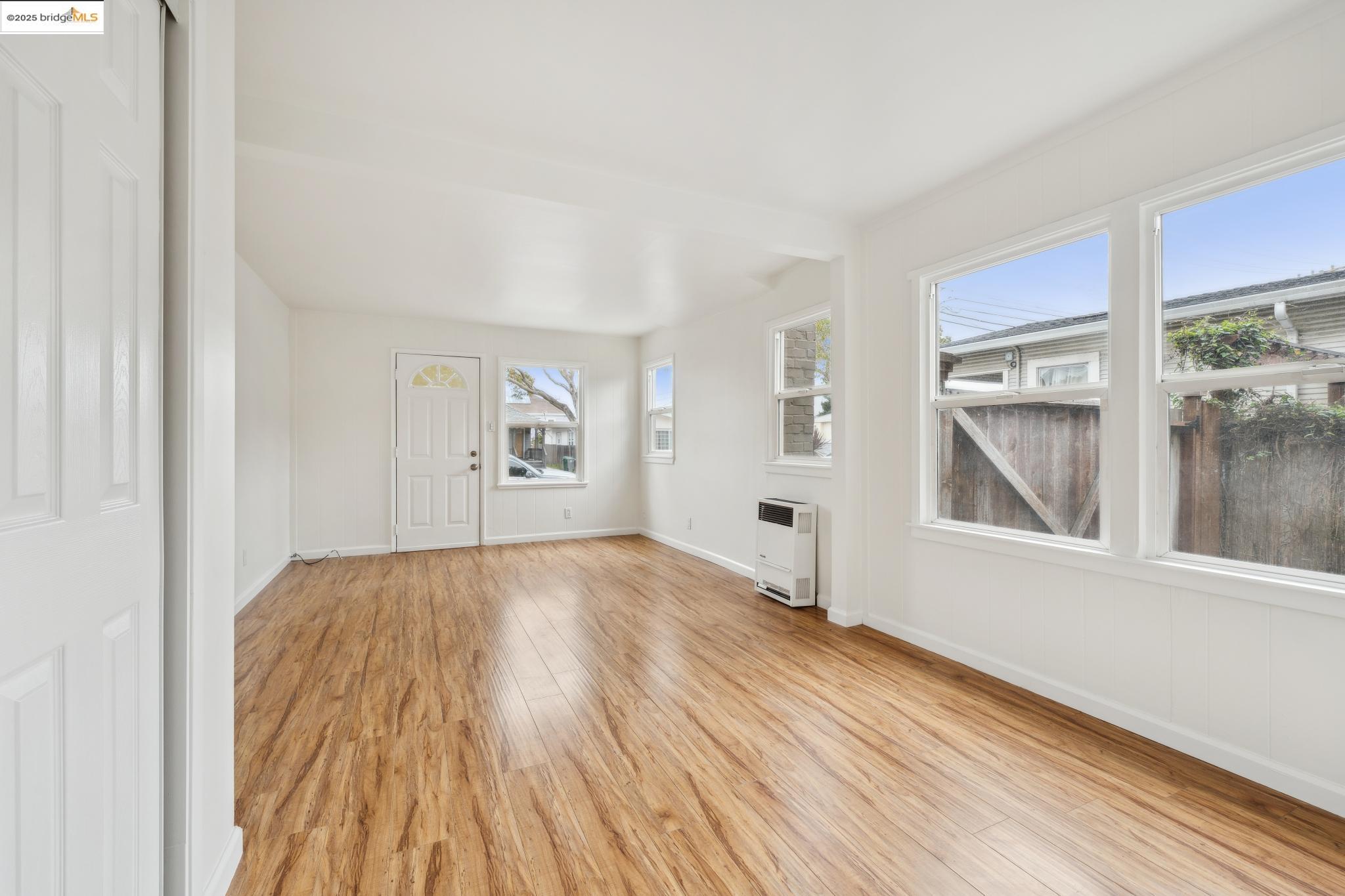 1226 Russell Street Berkeley, CA 94702 - Photo 12 of 32 a view of empty room with wooden floor and fan