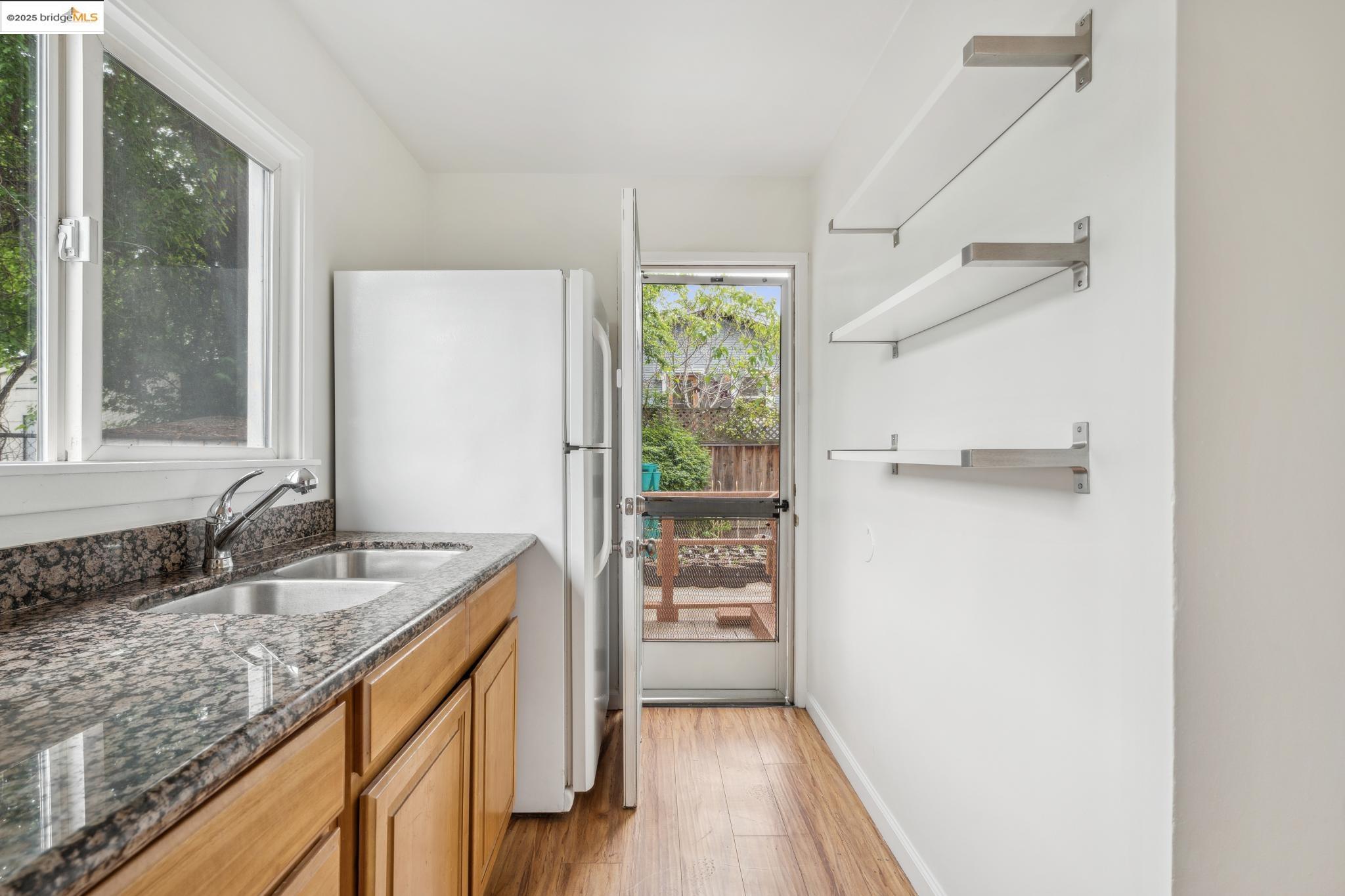 1226 Russell Street Berkeley, CA 94702 - Photo 15 of 32 a bathroom with a granite countertop sink a mirror and a bathtub