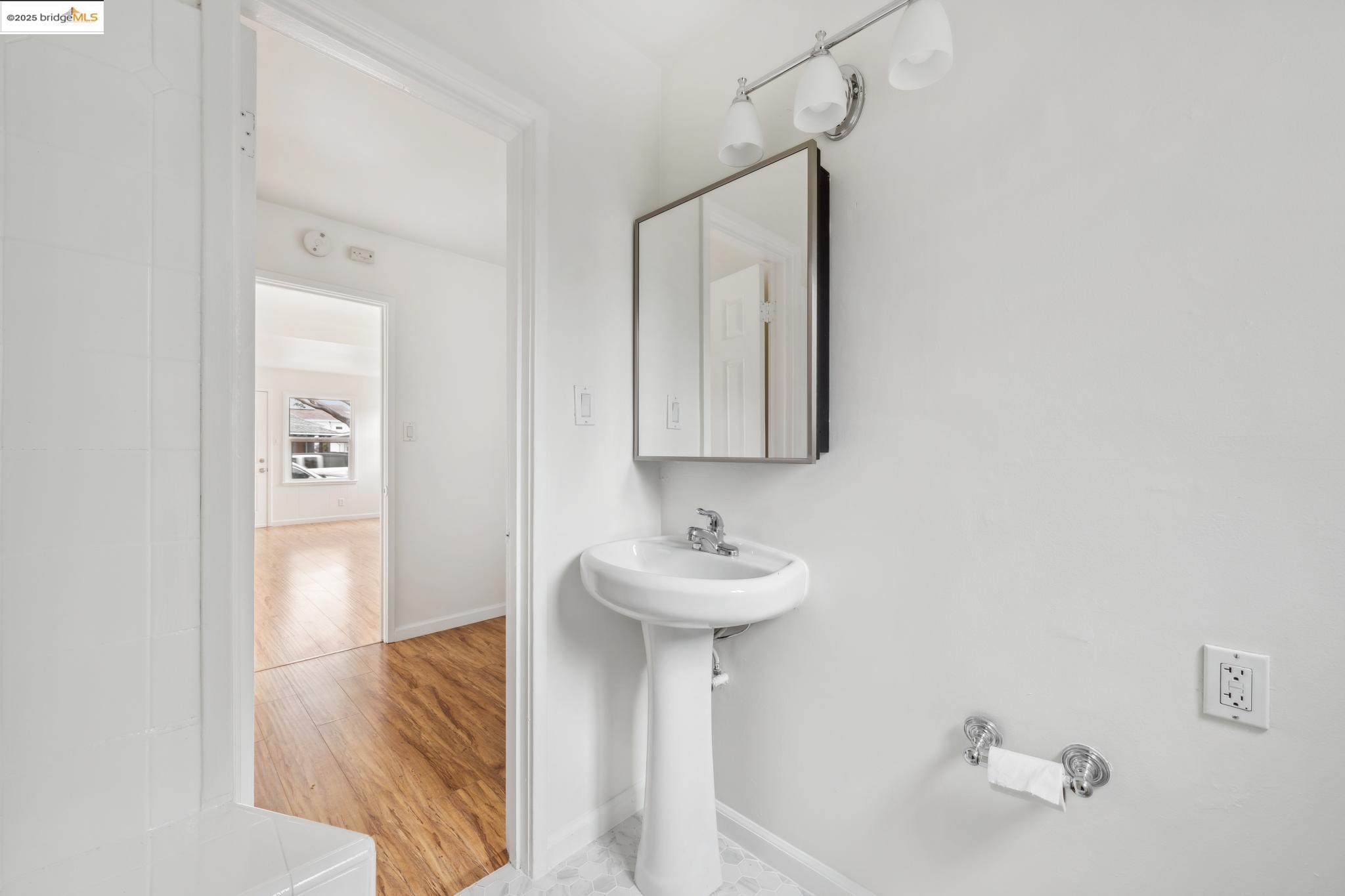 1226 Russell Street Berkeley, CA 94702 - Photo 16 of 32 a bathroom with a sink and a mirror
