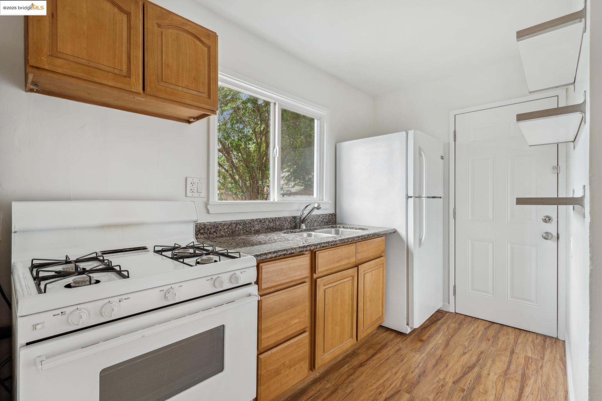 1226 Russell Street Berkeley, CA 94702 - Photo 18 of 32 a kitchen with granite countertop a stove and a refrigerator