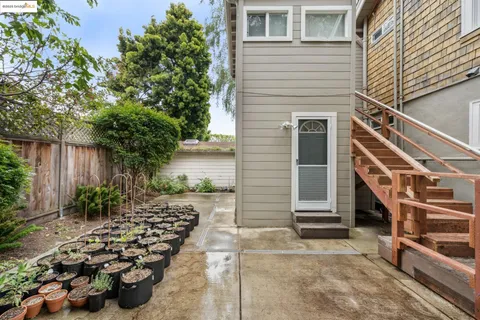 a view of a house with backyard and sitting area