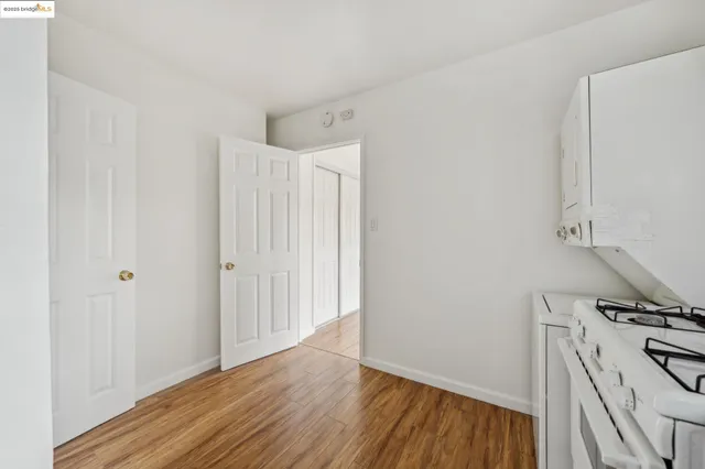 a view of a kitchen with wooden floor and electronic appliances