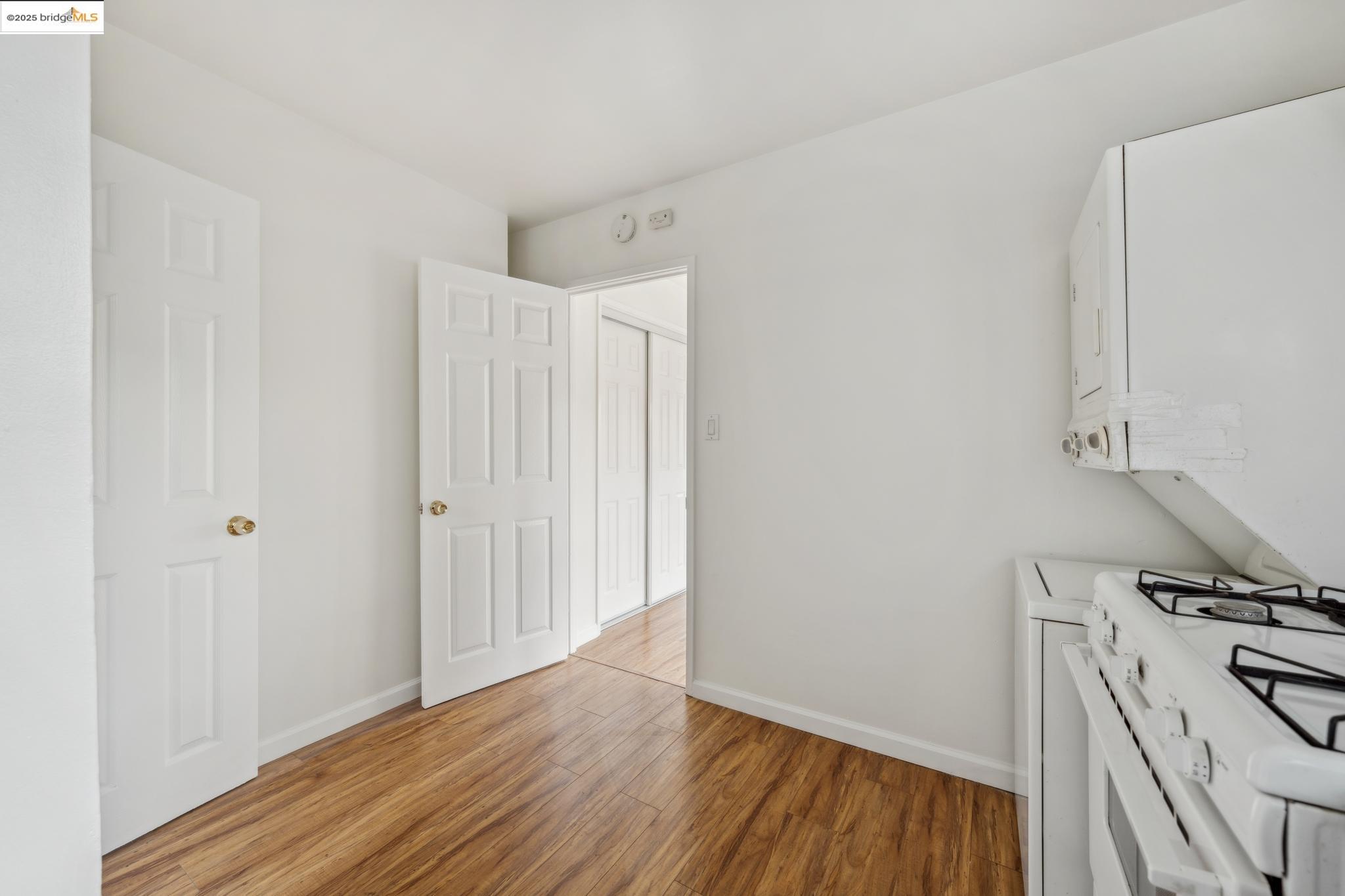 1226 Russell Street Berkeley, CA 94702 - Photo 25 of 32 a view of a kitchen with wooden floor and electronic appliances