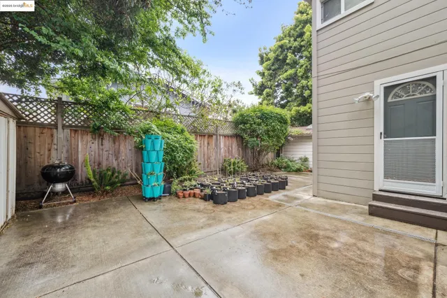 a view of a chair and table in backyard of the house