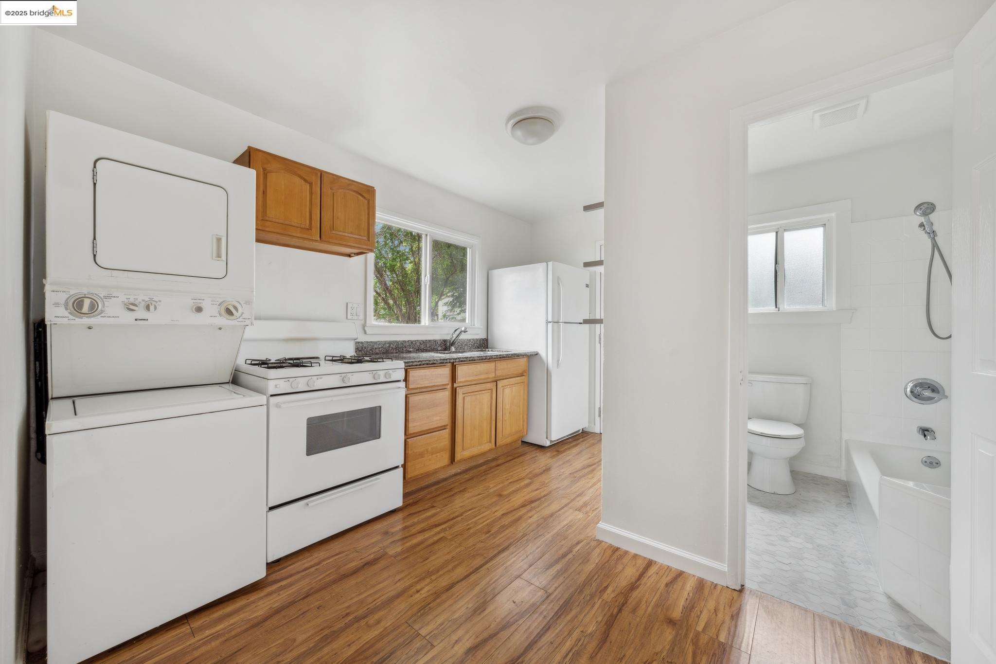 1226 Russell Street Berkeley, CA 94702 - Photo 28 of 32 a kitchen with a white stove top oven and white appliances