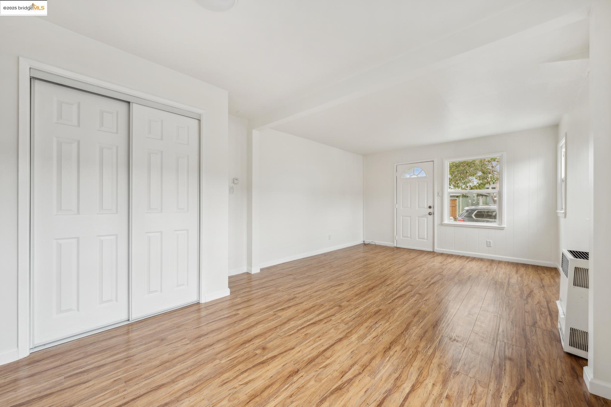 1226 Russell Street Berkeley, CA 94702 - Photo 30 of 32 a view of an empty room with wooden floor and a window