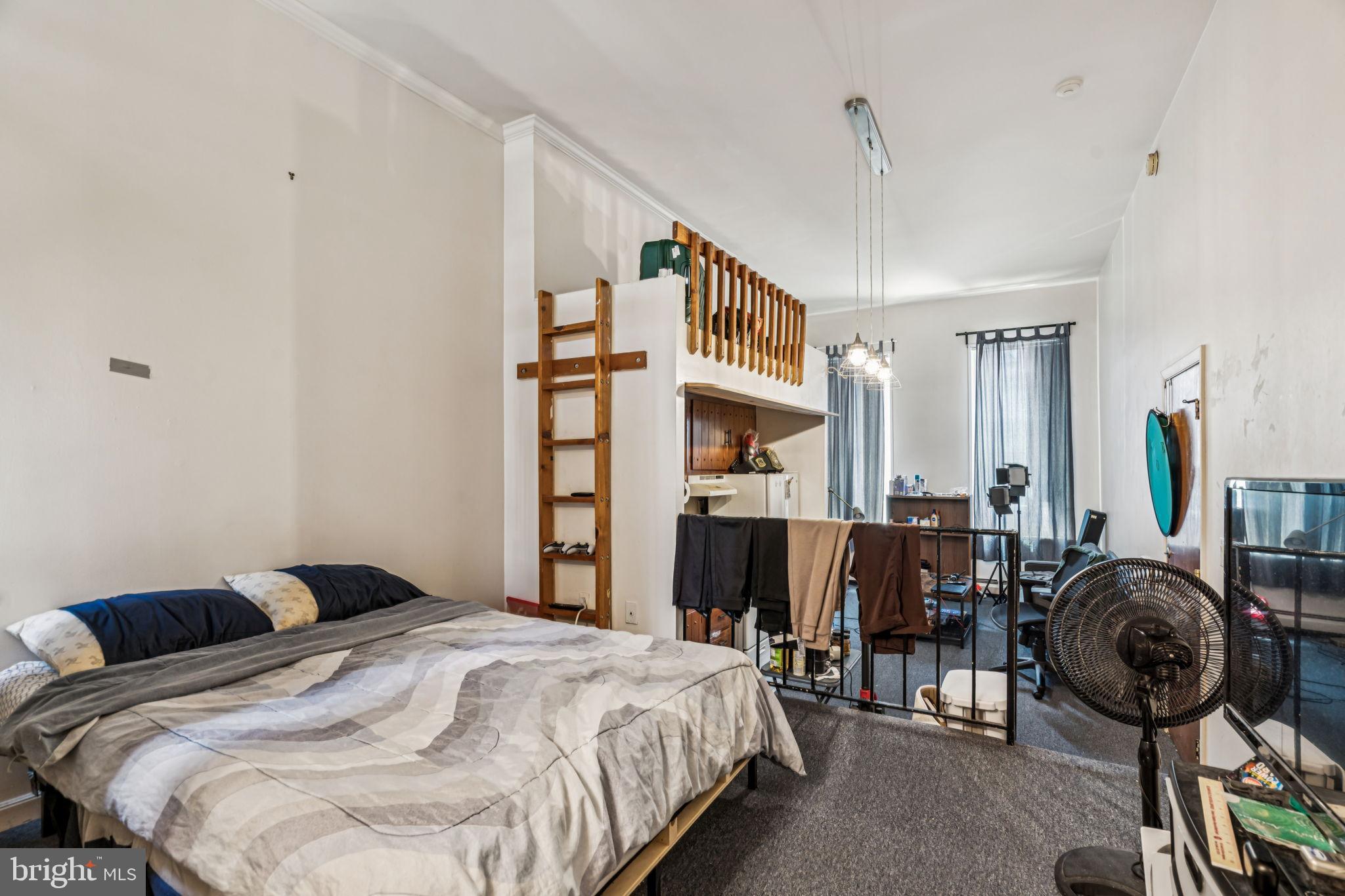 1917 Spring Garden Street, Unit 1 Philadelphia, PA 19130 - Photo 4 of 5 a bedroom with bed a table and chair