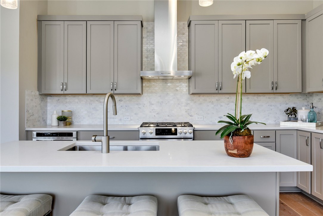 a kitchen with a white sink and cabinets