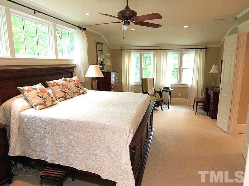 2327 Byrd Street Raleigh, NC 27608 - Photo 13 of 25 a spacious bedroom with a bed a table and large windows