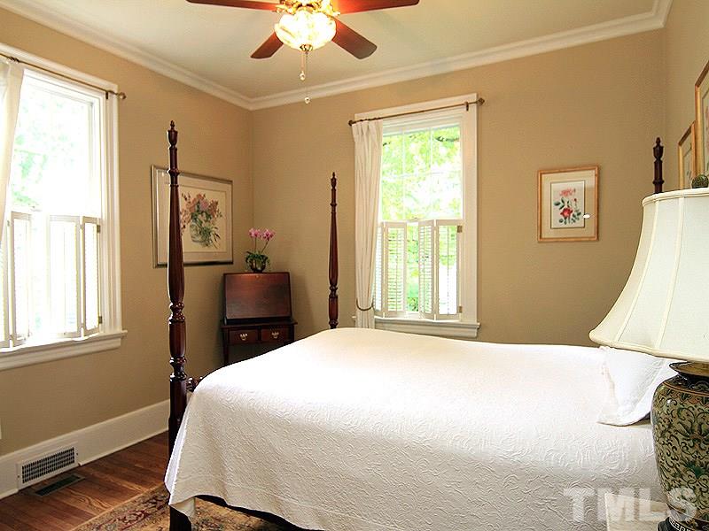 2327 Byrd Street Raleigh, NC 27608 - Photo 19 of 25 a bedroom with a bed and a chandelier