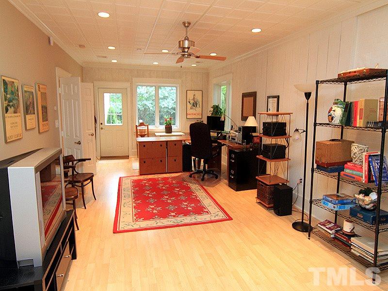 2327 Byrd Street Raleigh, NC 27608 - Photo 21 of 25 a living room with furniture a flat screen tv and a dining table