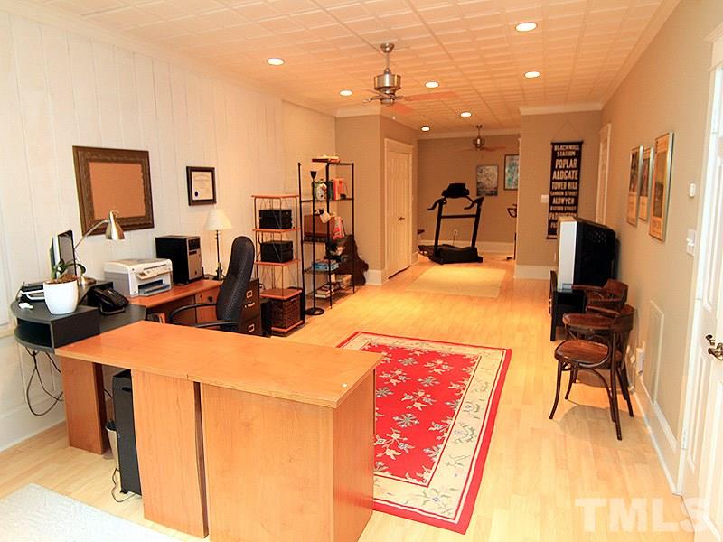 2327 Byrd Street Raleigh, NC 27608 - Photo 22 of 25 a living room with furniture a flat screen tv and a table