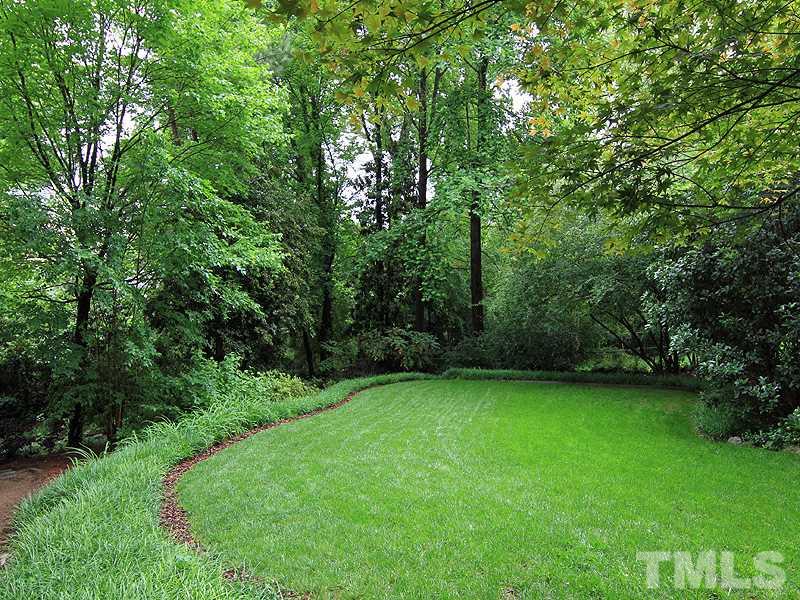 2327 Byrd Street Raleigh, NC 27608 - Photo 23 of 25 a view of a green field with trees in the background