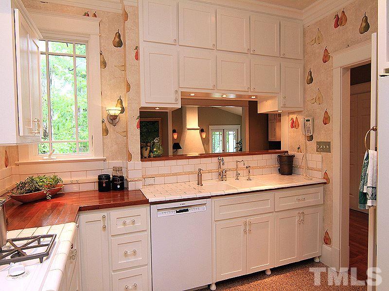 2327 Byrd Street Raleigh, NC 27608 - Photo 8 of 25 a kitchen with cabinets appliances a sink and a window