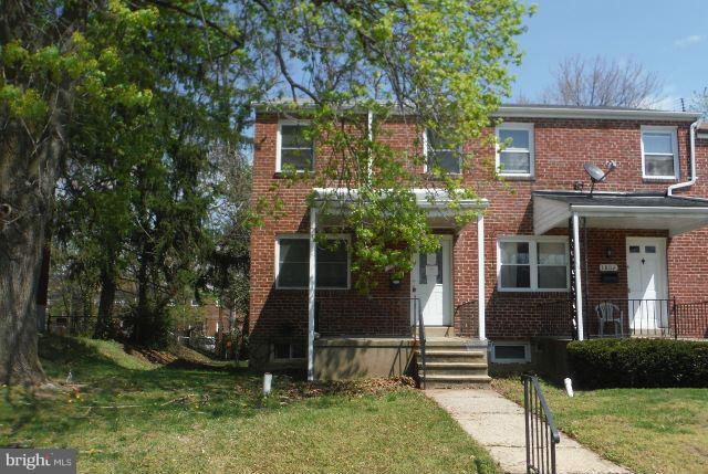 1800 Swansea Road Baltimore, MD 21239 - Photo 1 of 8 front view of a house with a yard