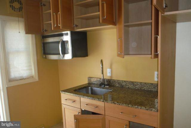 1800 Swansea Road Baltimore, MD 21239 - Photo 2 of 8 a bathroom with a sink and a mirror