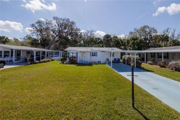 a view of a house with swimming pool and sitting area