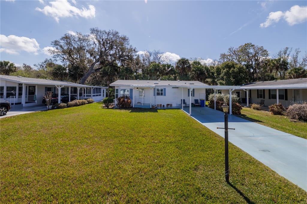 a view of a house with swimming pool and sitting area