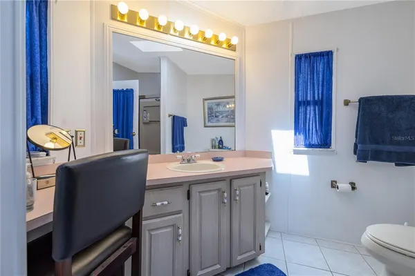 a kitchen with a sink cabinets and wooden floor