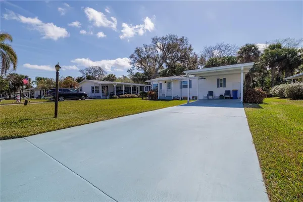 a view of a house with a yard and sitting area