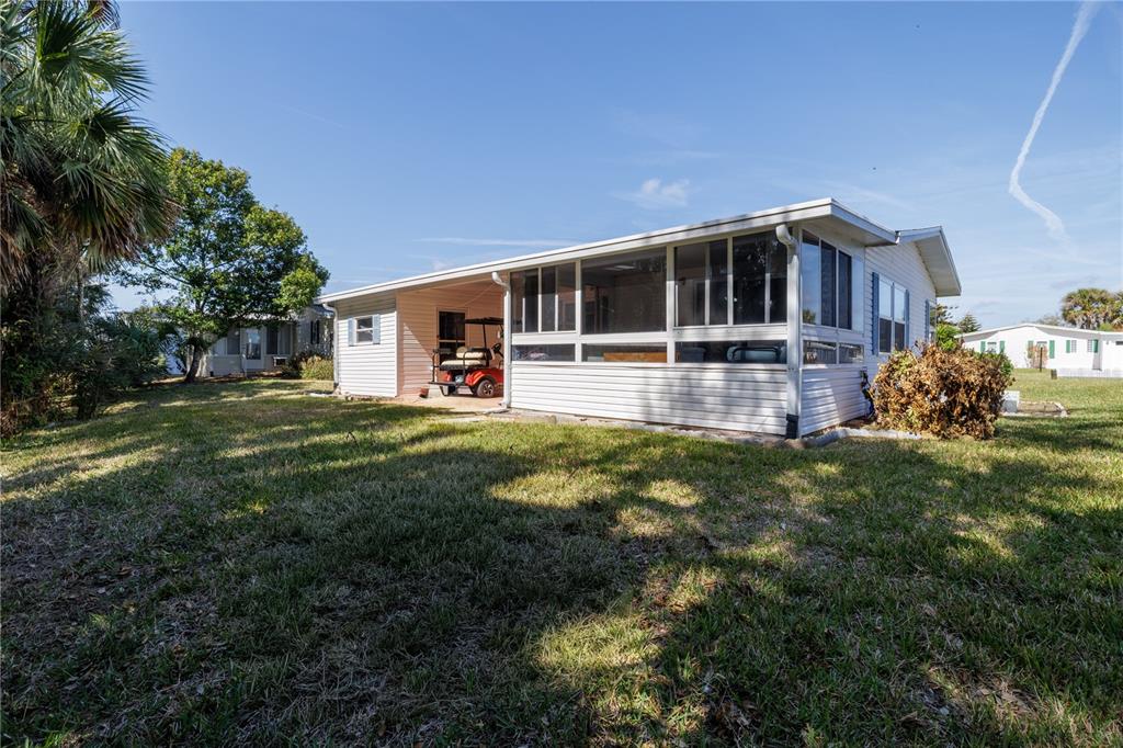 810 Navigators Way Edgewater, FL 32141 - Photo 20 of 34 a front view of house with yard and green space