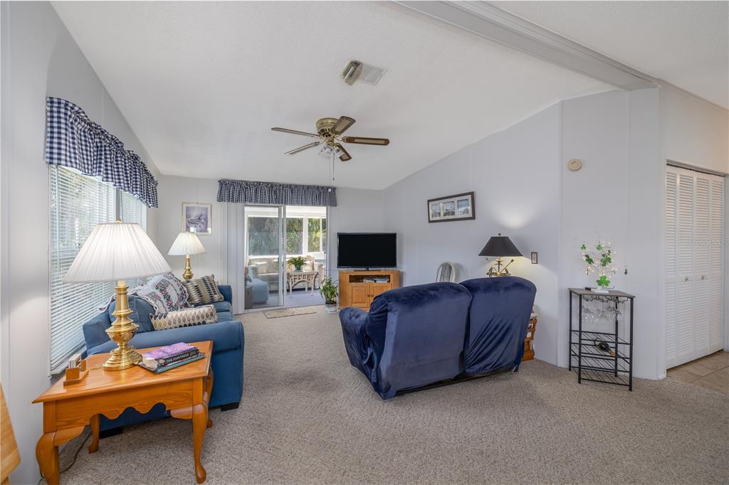810 Navigators Way Edgewater, FL 32141 - Photo 3 of 34 a living room with furniture and a flat screen tv