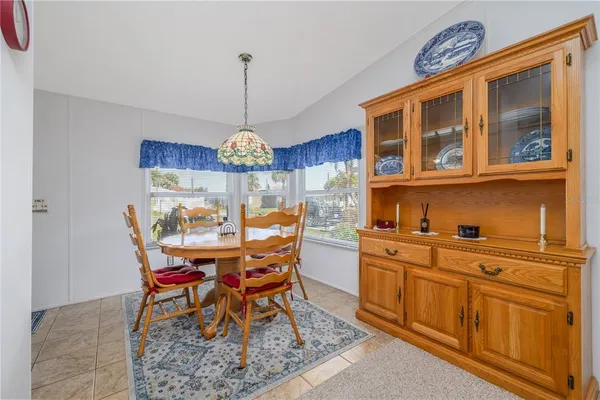 a view of a dining room with furniture a chandelier and wooden floor