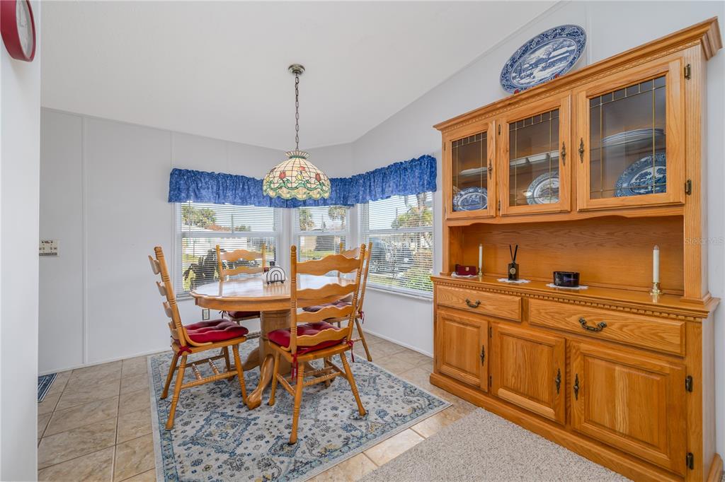 810 Navigators Way Edgewater, FL 32141 - Photo 8 of 34 a view of a dining room with furniture a chandelier and wooden floor