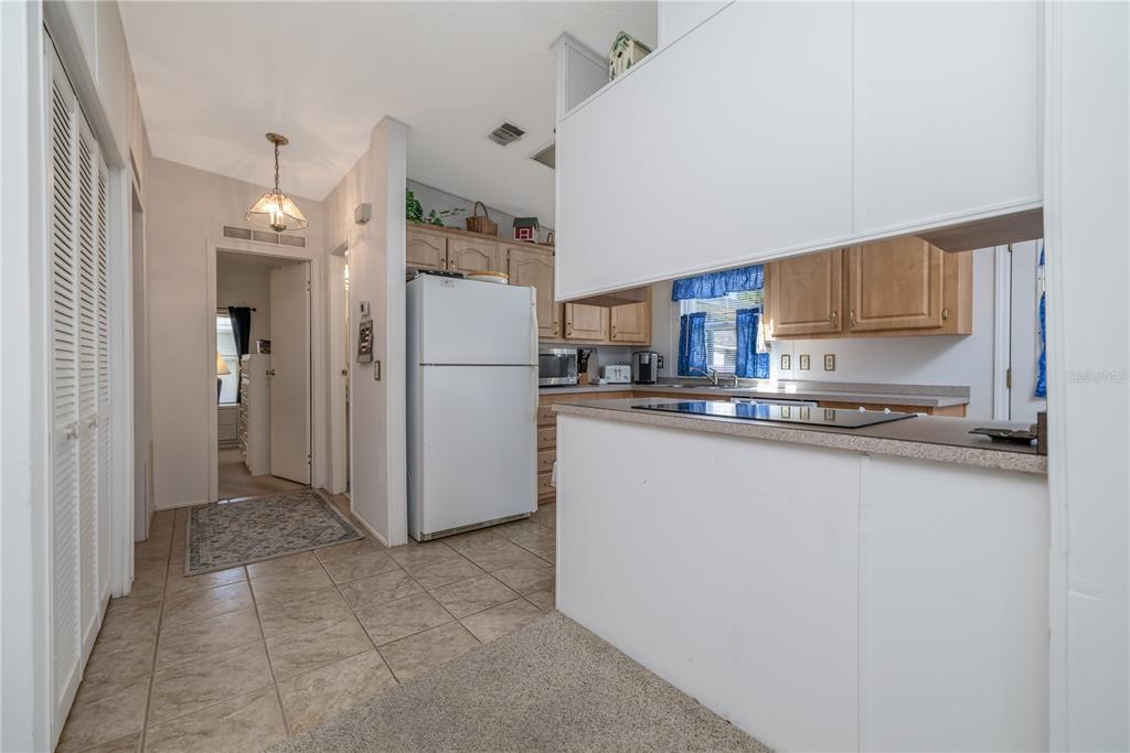 810 Navigators Way Edgewater, FL 32141 - Photo 9 of 34 a kitchen with refrigerator and cabinets