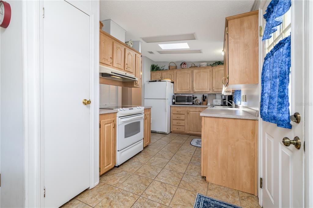 810 Navigators Way Edgewater, FL 32141 - Photo 10 of 34 a kitchen with a stove top oven sink and cabinets