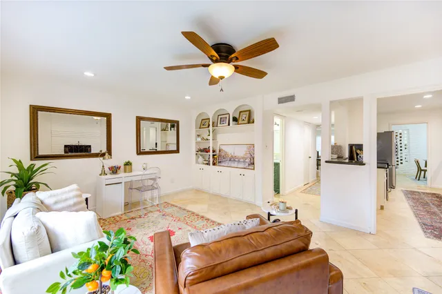 a living room with furniture and a potted plant