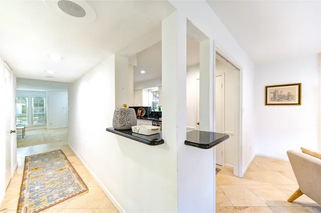 a bathroom with a granite countertop sink a toilet and a mirror