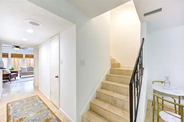 a bed room with a bed and a ceiling fan