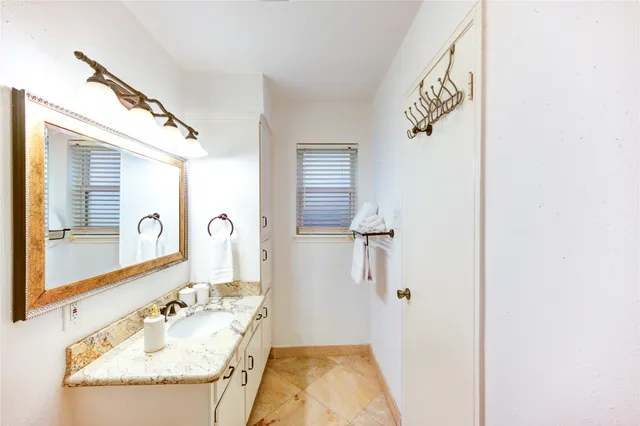 a bathroom with a sink vanity mirror and toilet