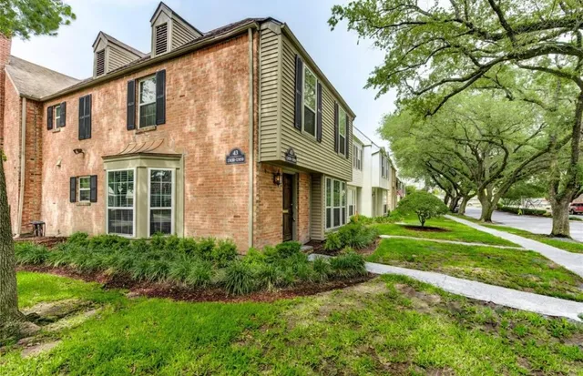 a front view of a house with yard and green space