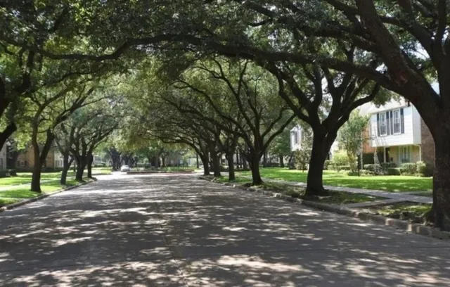 a view of a park with iron fence