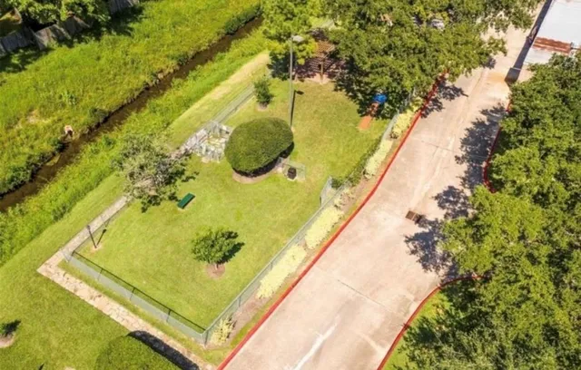 an aerial view of a house with a yard and garden
