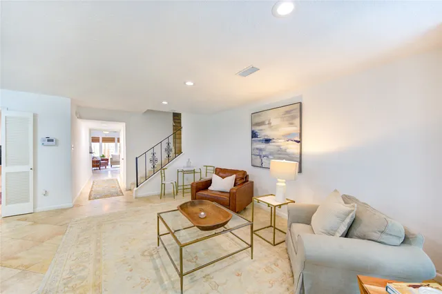 a dining room with furniture and a rug