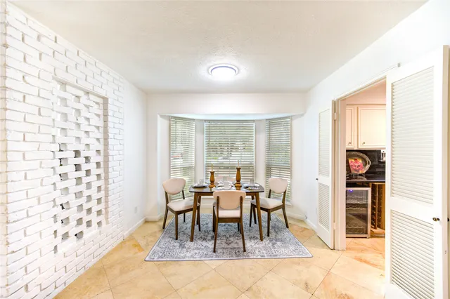 a view of a dining room with furniture and a window