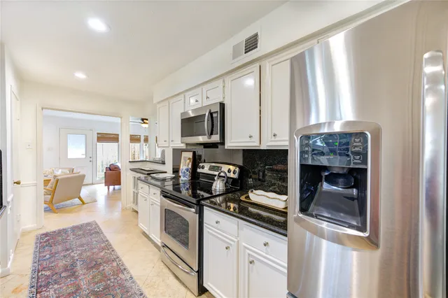 a kitchen with a stove and a sink