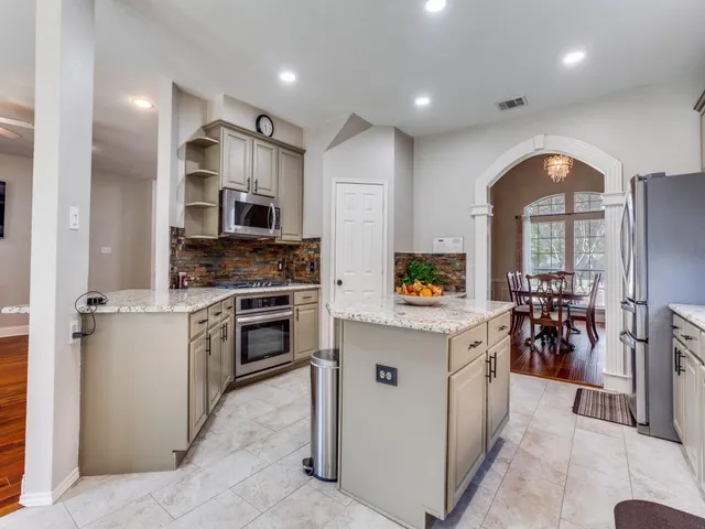 a kitchen with a sink stainless steel appliances and cabinets