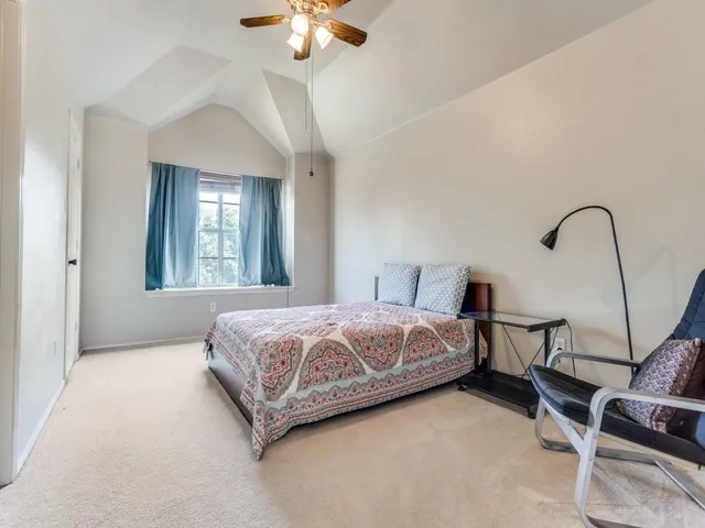 a bedroom with bed and a chandelier